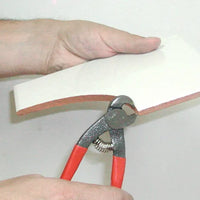 Rubi parrot-beak nippers trimming a tile edge