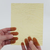 Video of the pale amber ripple glass plate in yellow transparent, 15x19cm, held up and tilted to show its pattern and transparency