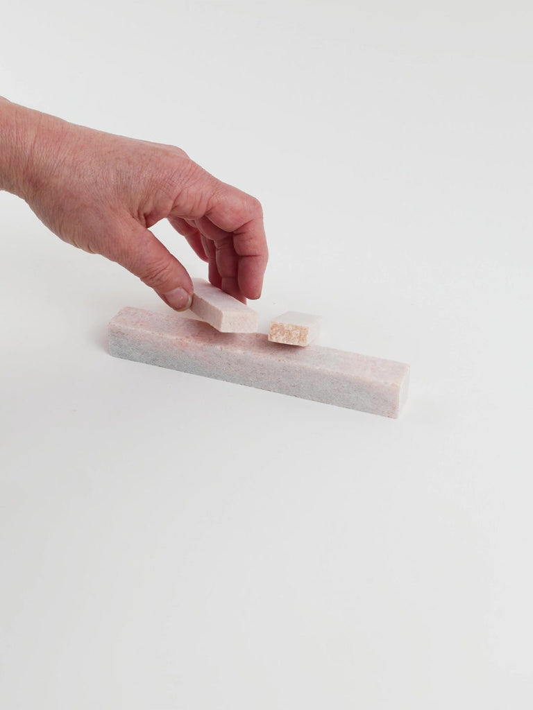Video of Marble Bars XL Rosa Porta in opaque pink natural marble, 1–20 cm long and 8 mm thick, picked up by hand and turned to show their length, colour and natural veining