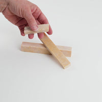 Video of Marble Bars XL Giallo Reale in opaque orange-yellow natural marble, 1–20 cm long and 8 mm thick, picked up by hand and turned to show their length, colour and natural veining