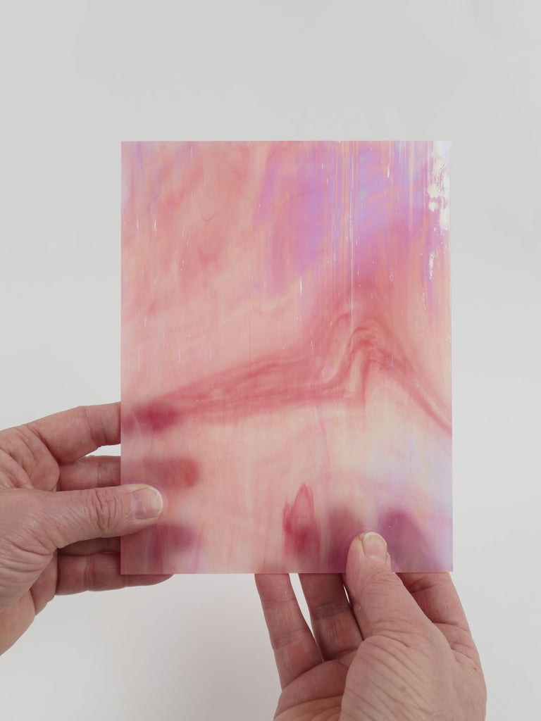 Video of the Rosebud glass plate in iridescent translucent pink, 15x19cm, held up and tilted to show its pattern and transparency